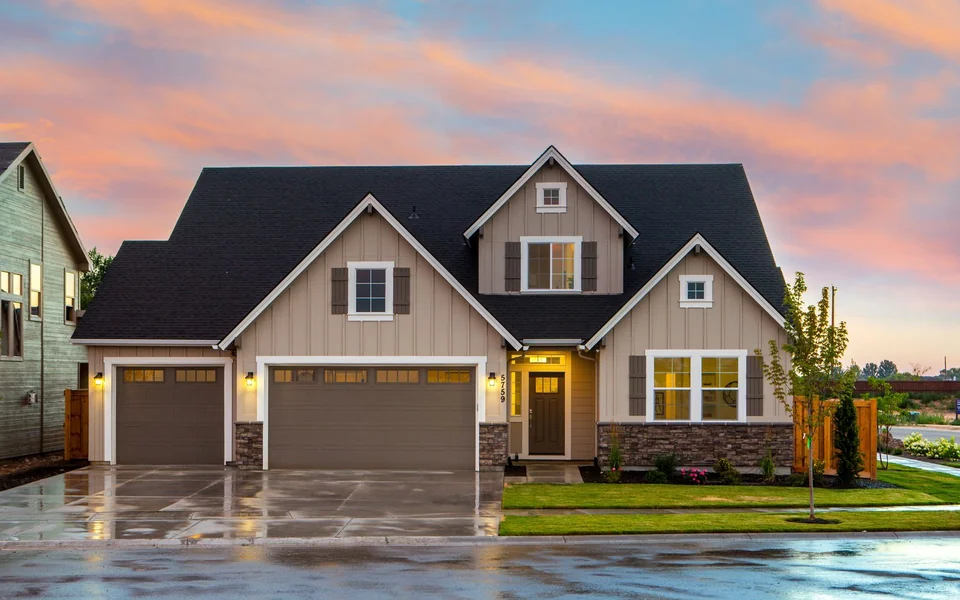 A home with illuminated entrances and windows at dusk